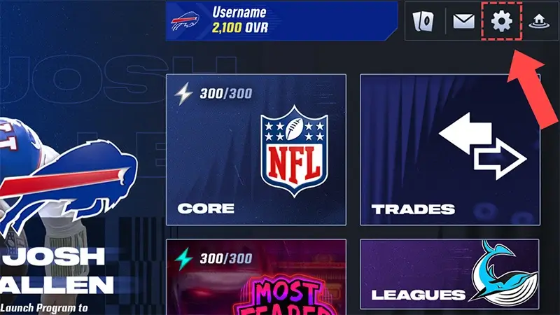 A coral arrow pointing to the cogwheel in Madden NFL 24 Mobile.
